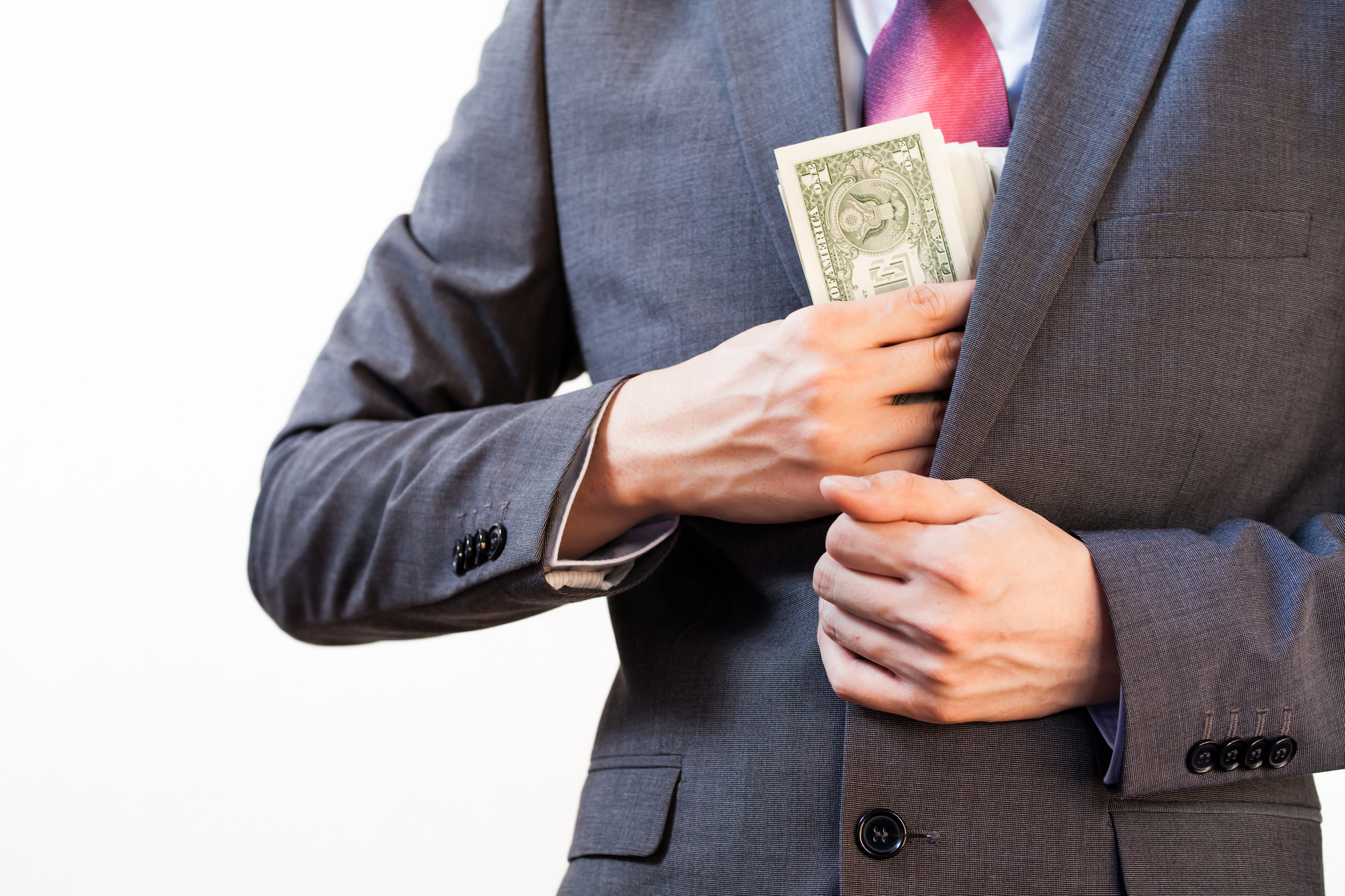 Business man hiding money in jacket pocket